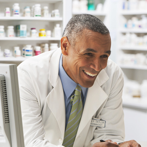 Decorative: Image of a provider in a white lab coat leaning on counter and smiling.