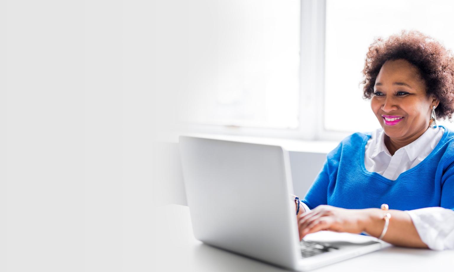 happy woman looking at laptop