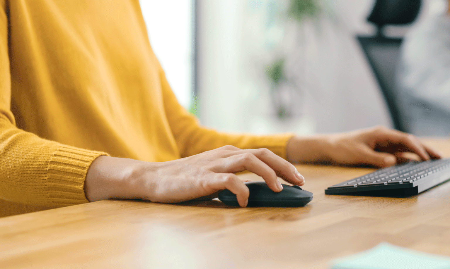 image of hands typing on a keyboard and using a computer mouse